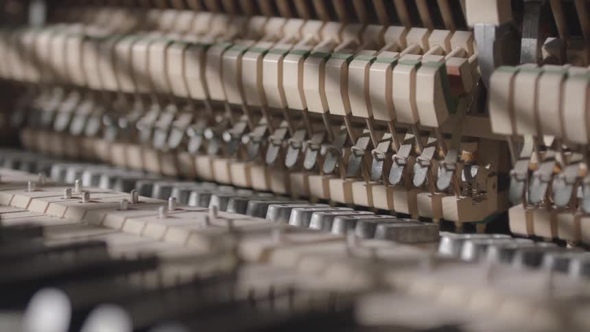 Close up of wooden and metal keys of a piano