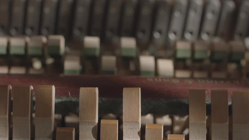 A closeup shows the intricate mechanism of a pianos action