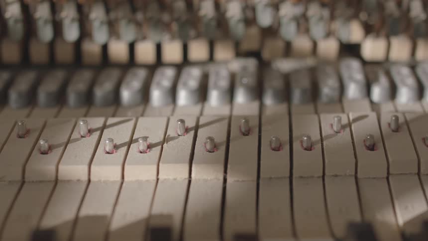 The internal mechanism of an upright piano moves up and down as it is being played