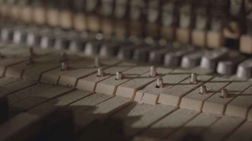 Moving wooden keys of a musical instrument