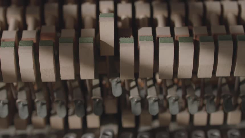 Hammers inside a piano move while the piano is played