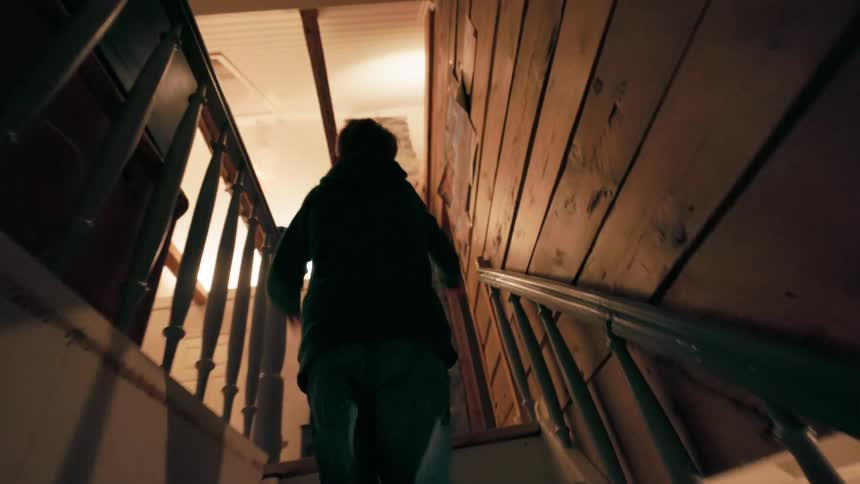 Child climbing the stairs of a house