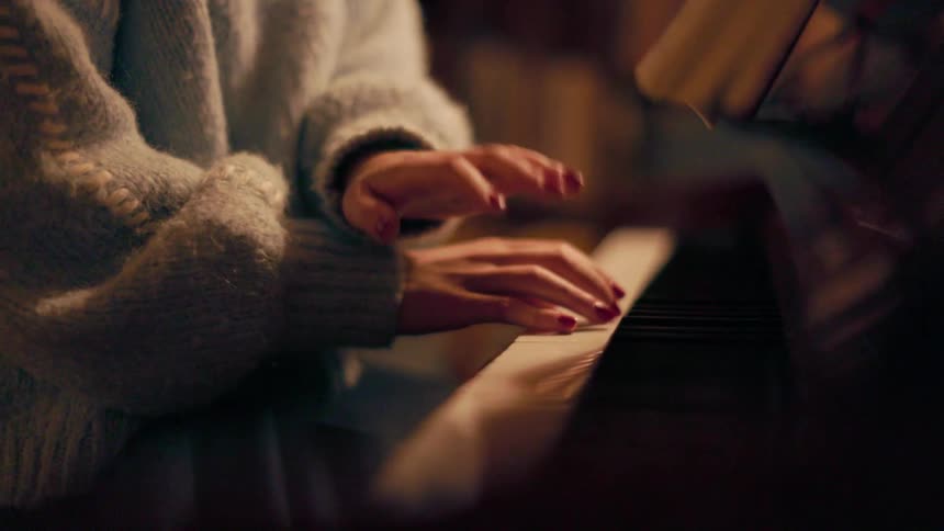 Pair of female hands playing piano