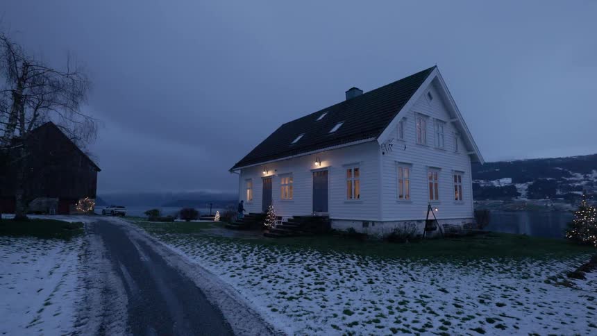Person entering a house in a snowy rural area