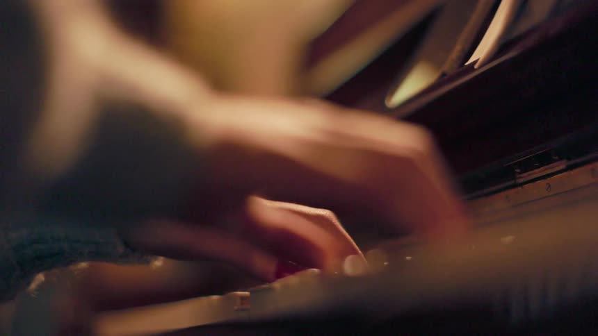 Close up of female hands playing piano