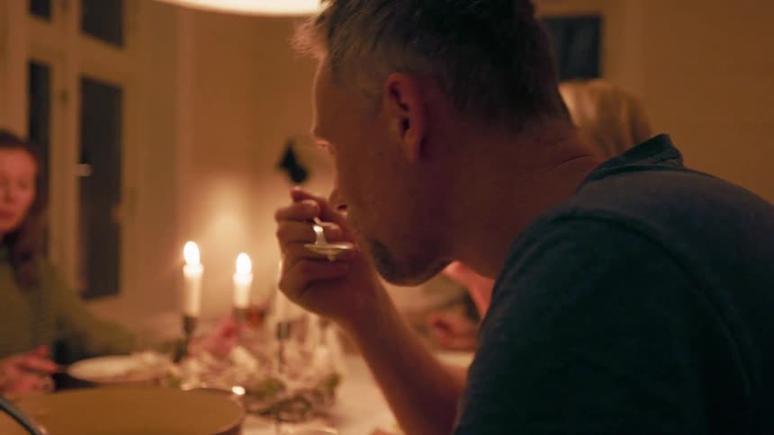 A family of five enjoying soup at the dinner table