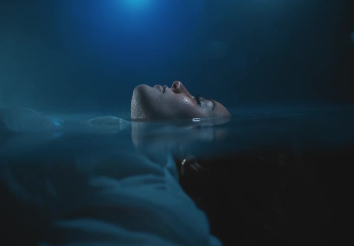 A woman is floating on her back in the water