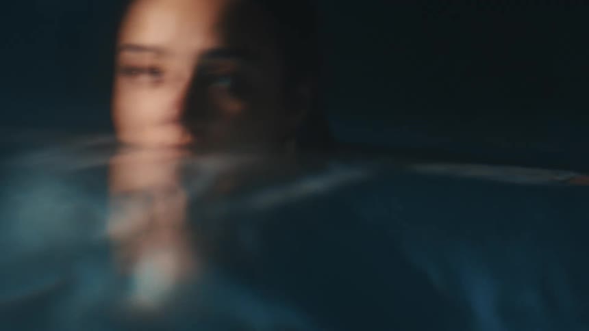 A woman is swimming in the pool