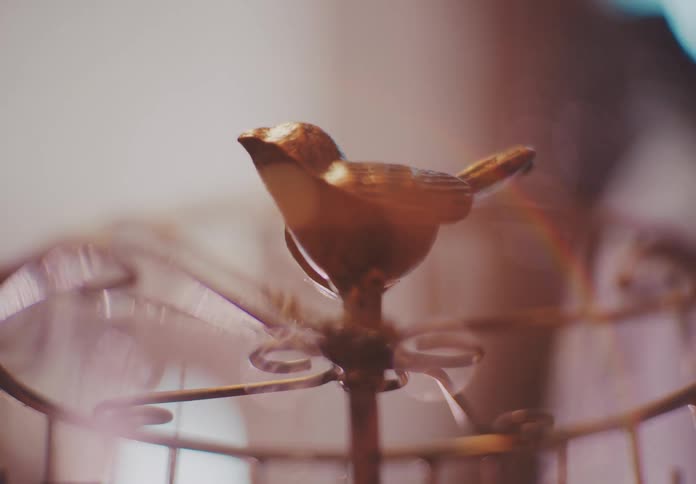 A metal sculpture of a bird is in the room