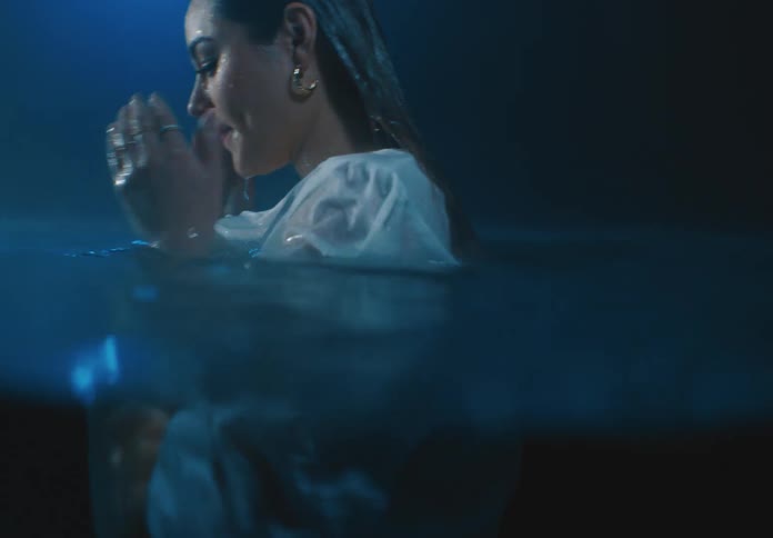 A woman swallows pool water and coughs