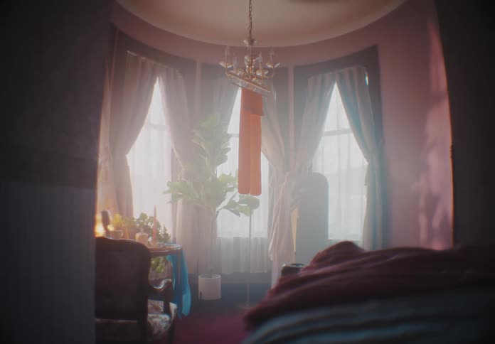 Orange scarf hanging from a lamp in a room