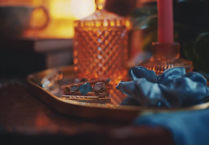The tray has a jar and jewelry on it