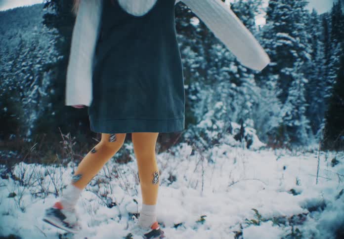 A woman is spinning in the snow