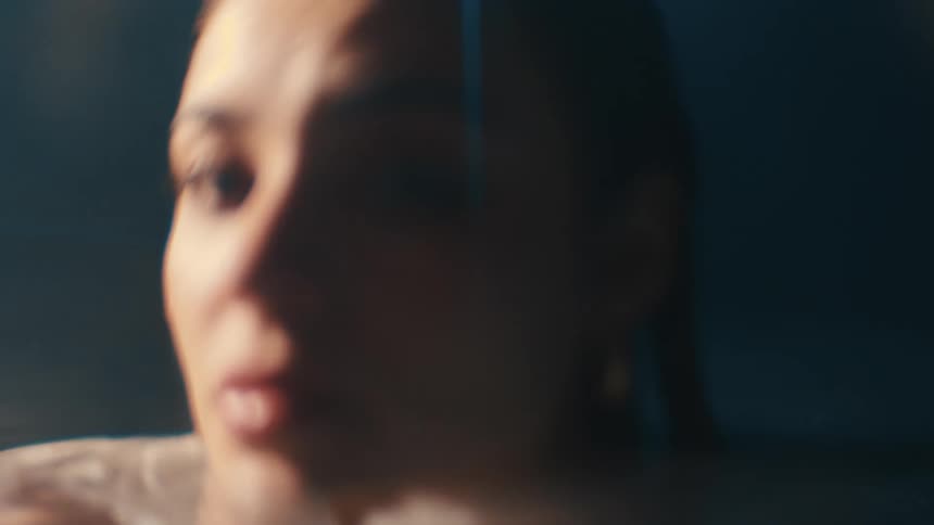 Woman with cold and trembling lips submerged in water