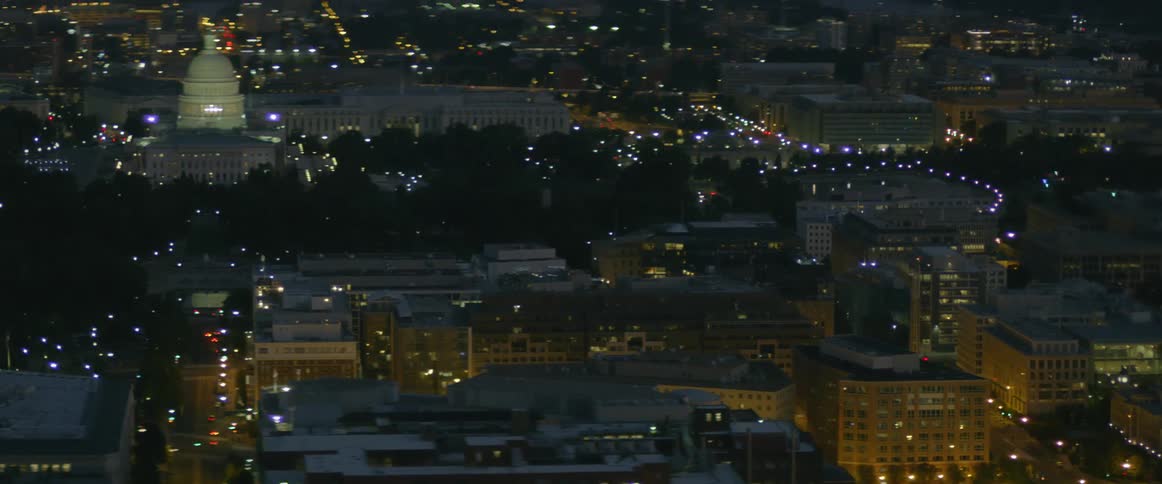 City buildings are shown at night