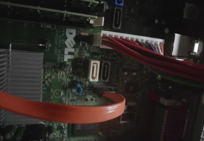 Closeup of a computers internal components highlighting its motherboard and connected wiring
