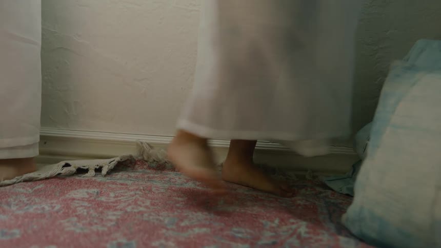 Two people are spinning in a circle with flowing motion viewed from a low angle