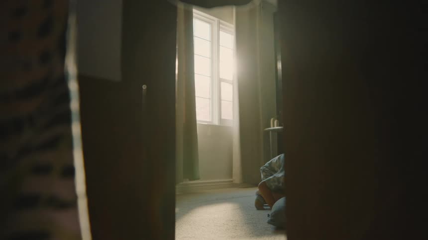 Boy looking for something in a room of the house