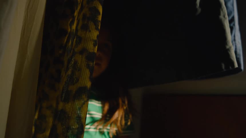 A child hiding in a closet in the bedroom