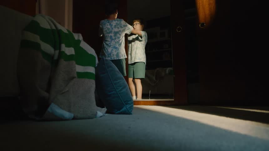 A boy entering the bedroom opening a closet and finding a girl who was hiding inside