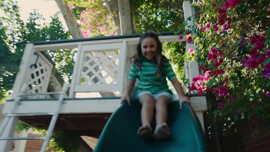 Girl having fun going down the slide