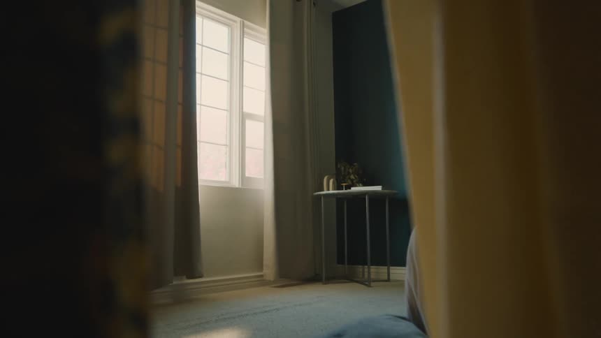 A bedroom with sunlight streaming through the window