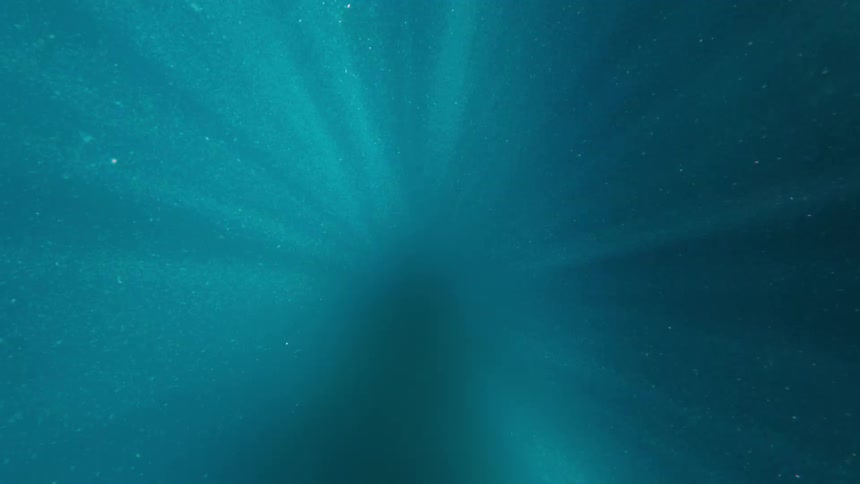 Underwater view of ocean with light reflection and glow