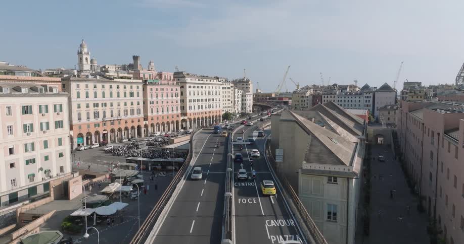 Aerial shot of a busy highway with vehicle traffic through a city