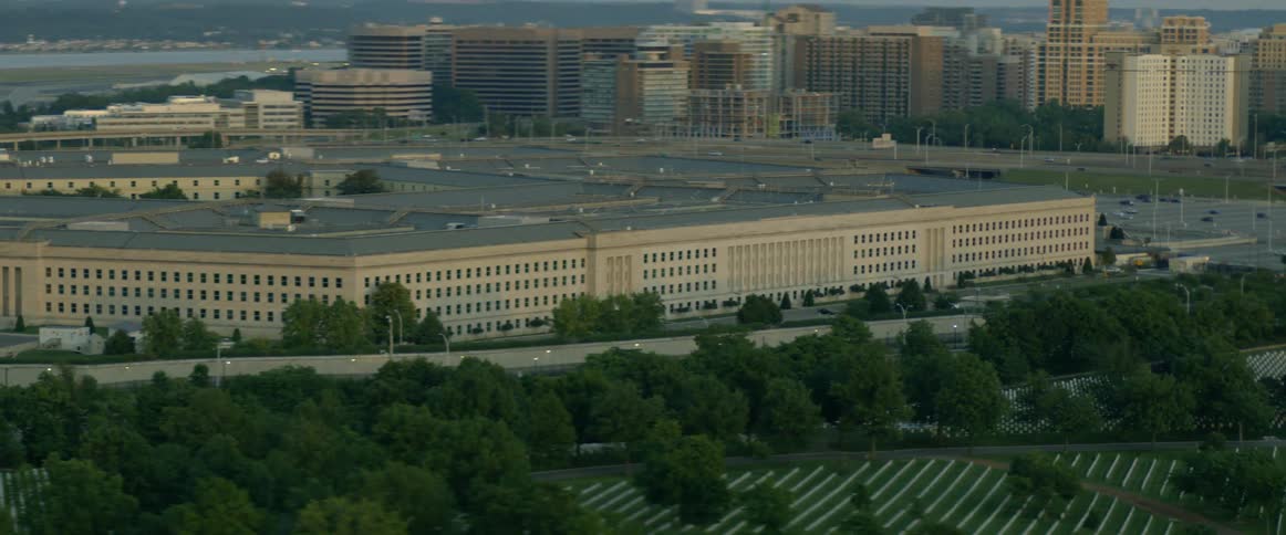 The pentagon building has a field before it