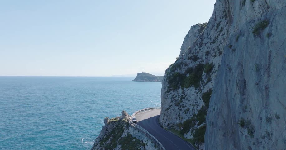 Aerial panorama of a highway on a mountain cliff by the sea