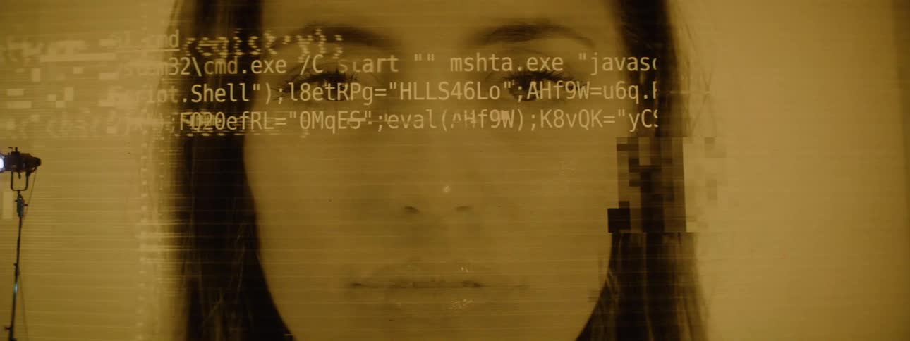 A clip of a male and females face displayed on a screen