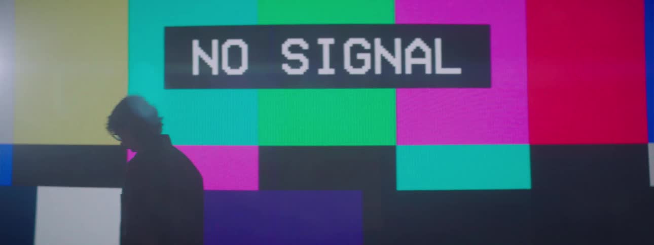 Person looks at screen with no signal and walks away hanging their head