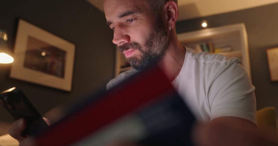 A man enters is credit card into a phone to make a purchase