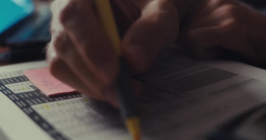 A close up clip of a person marking a document