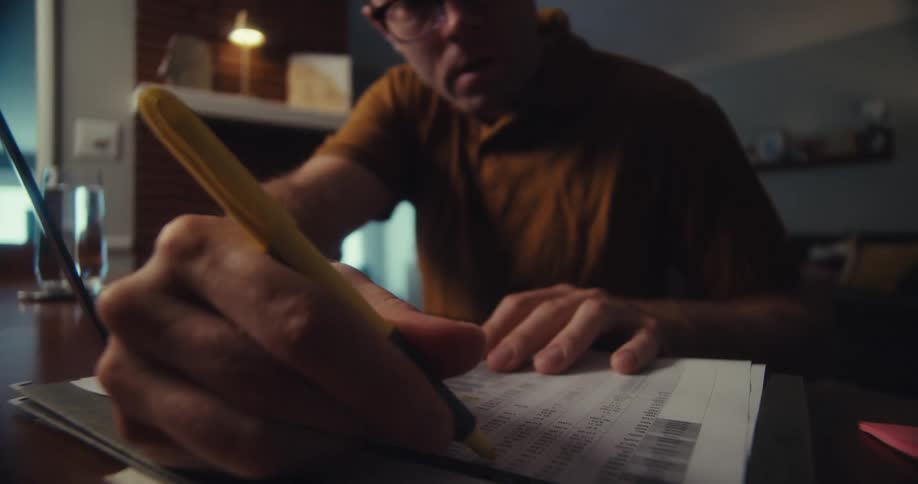 A footage of a man writing on a document