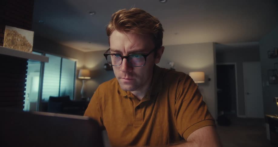 A footage of a person working on a laptop indoor