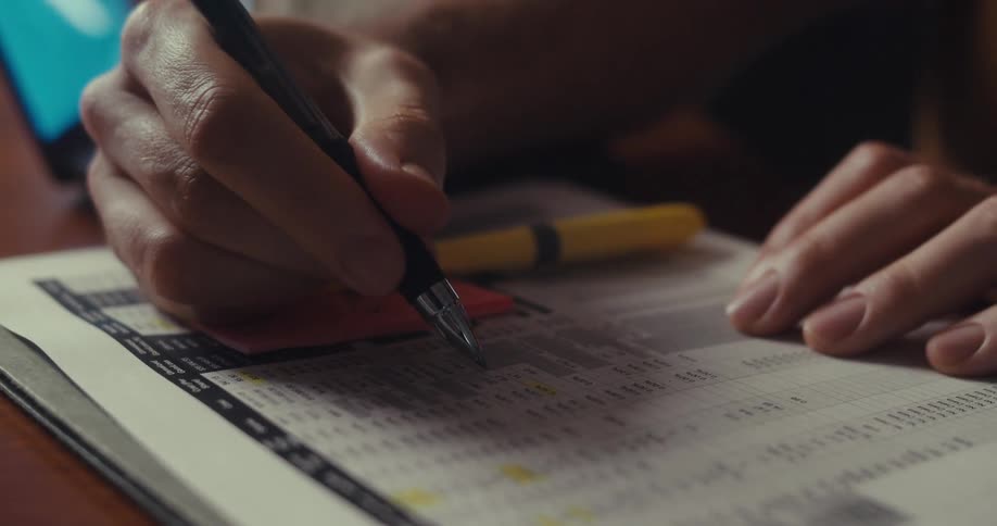 Man concentrating and using a pen on a document