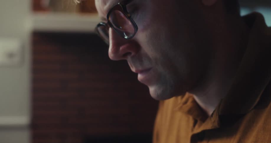 A man picks up his calculator at home