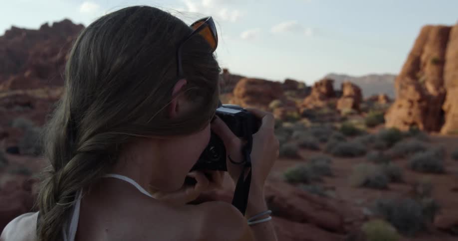 A woman is taking photographs of a cavern ahead