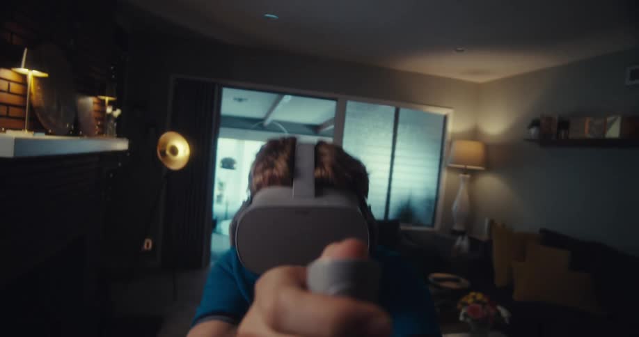 A man in a living room playing a virtual reality video game