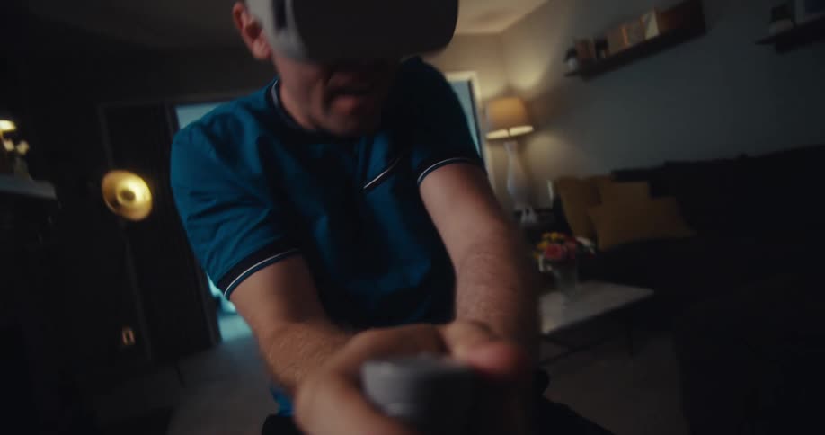 A footage of a man playing virtual reality indoor