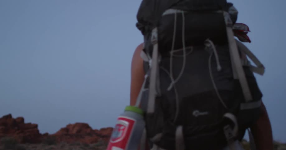 A man is hiking outside with a large backpack