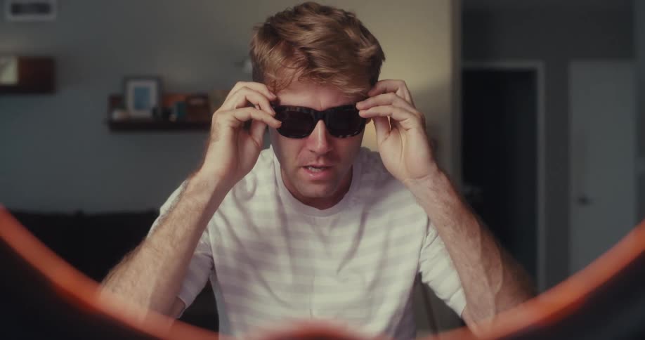 A footage of a man speaking and wearing an eyeglass