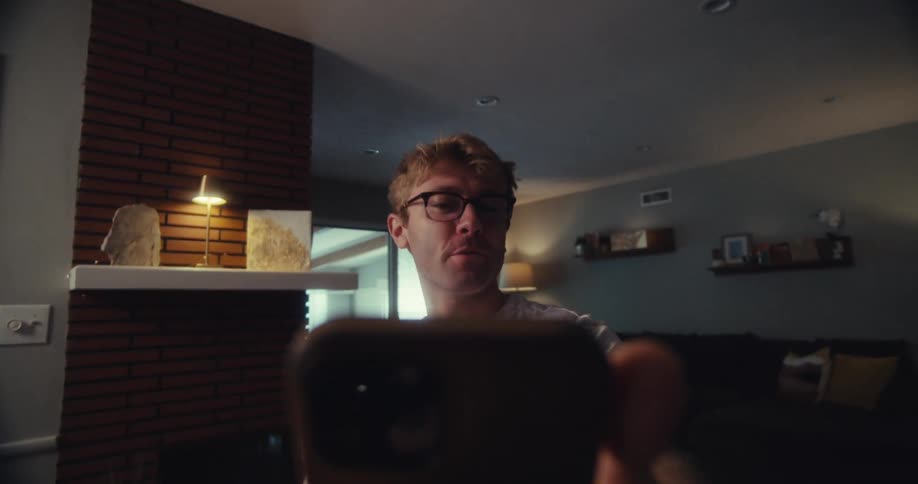 A joyful man records himself while excitedly explaining something to the camera