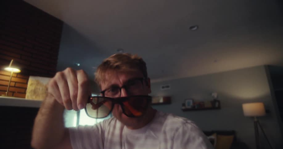 Blond man presenting sunglasses with brown lens