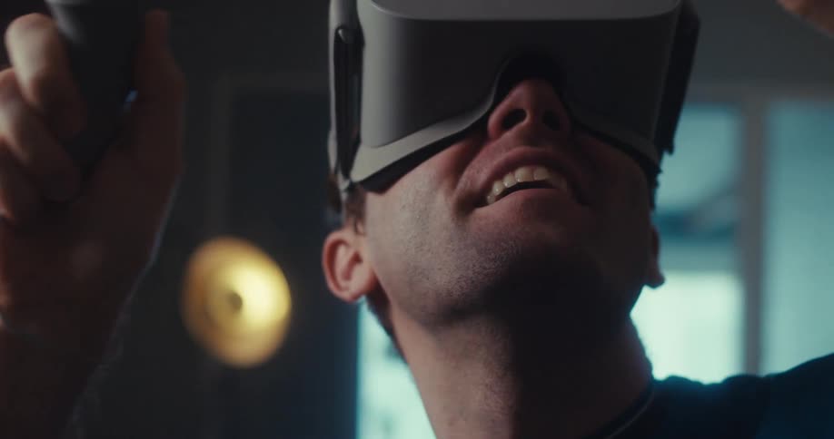 Man wearing a vr headset interacts with a virtual environment indoors