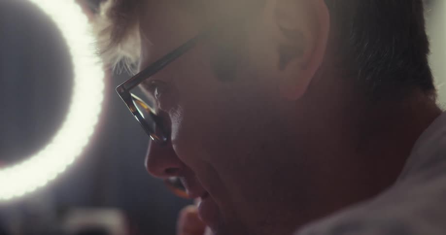A content creator enthusiastically records himself promoting sunglasses using a smartphone