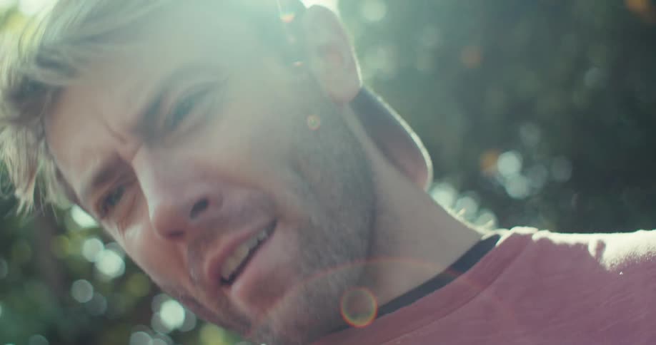 Man in cap outdoors talking happily