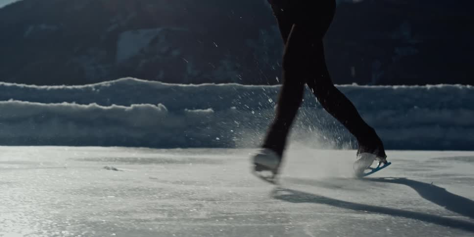 Ice skater twirling outdoors on a frozen pond