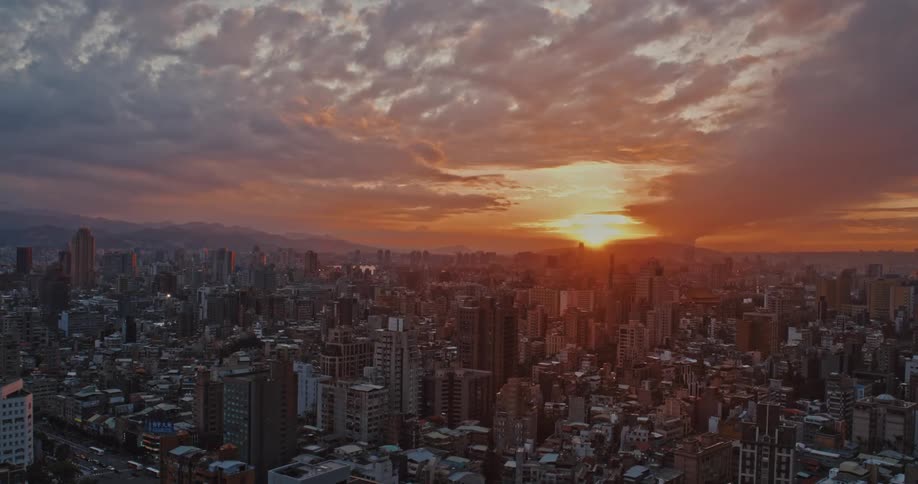 Aerial panorama of a metropolis with the sun rising on the horizon